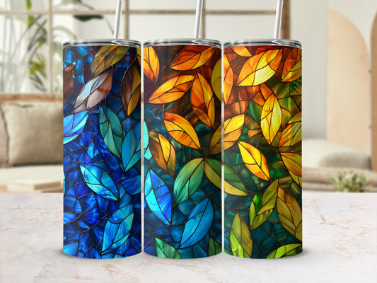 Three tumblers with stained-glass leaf patterns in blue, orange, and green.