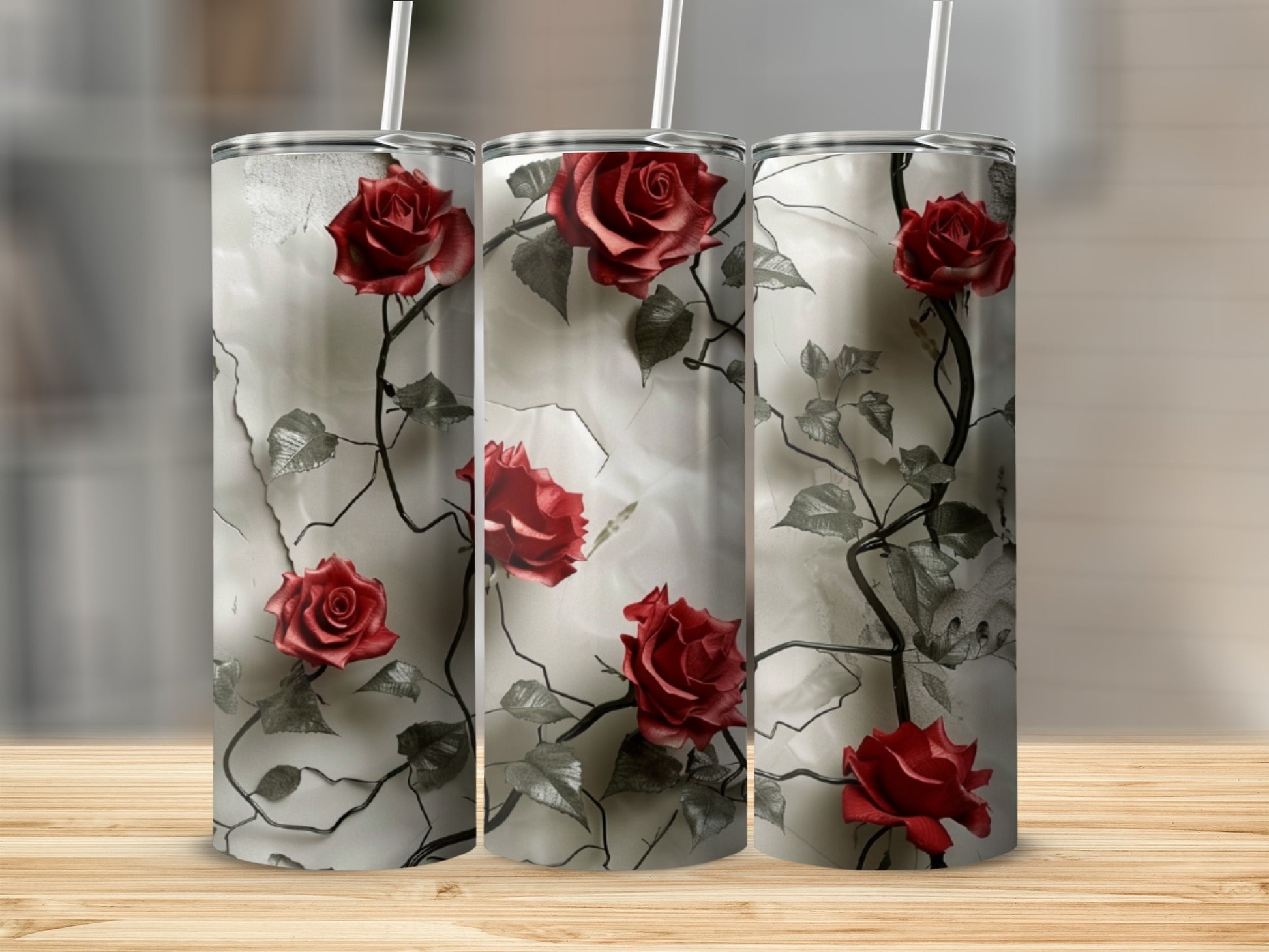 Three tumblers with a red rose and thorny vine design.