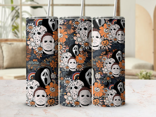 Horror movie masks and pumpkins on a floral background tumbler with straw.