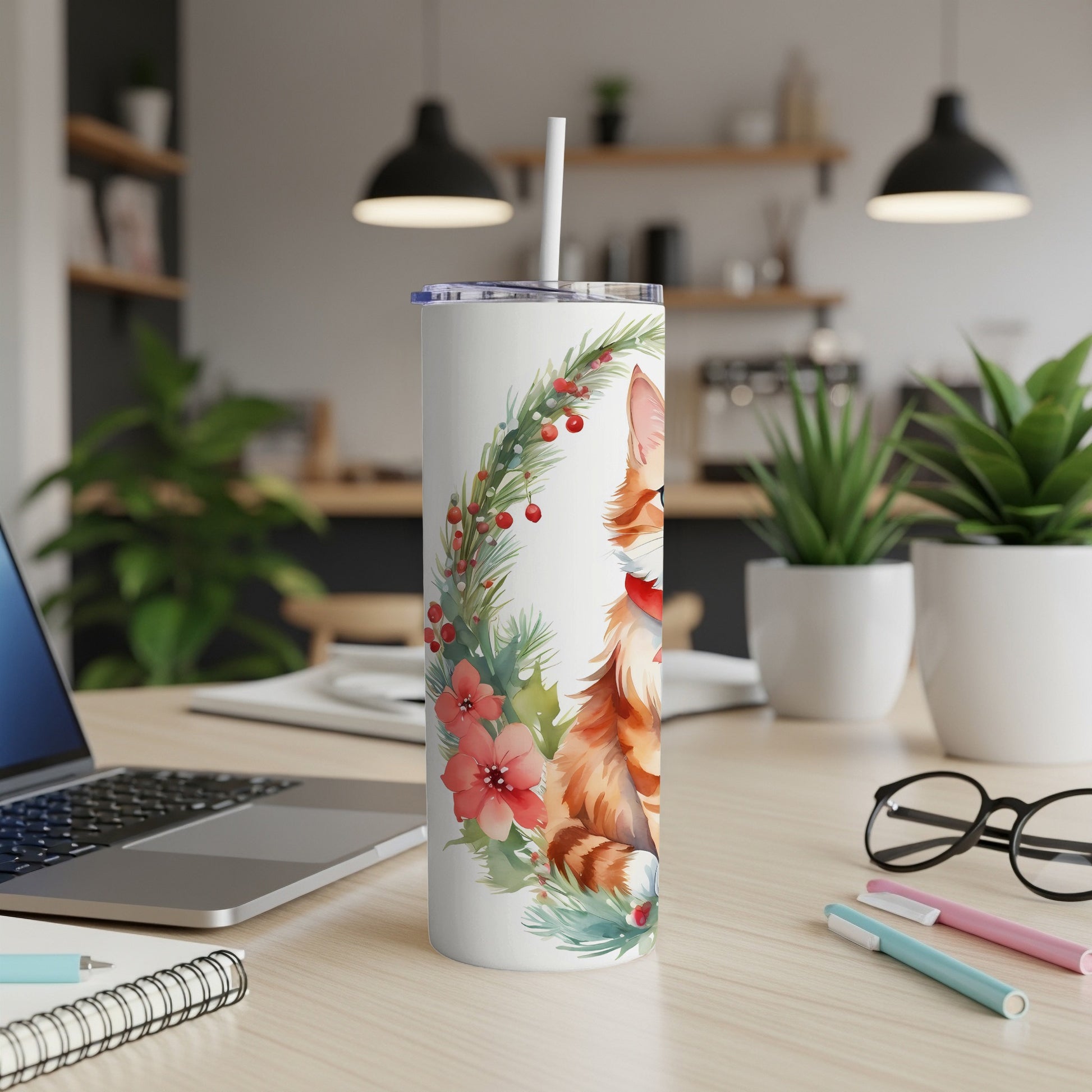 Ginger tabby cat in wreath with poinsettias on a white tumbler.