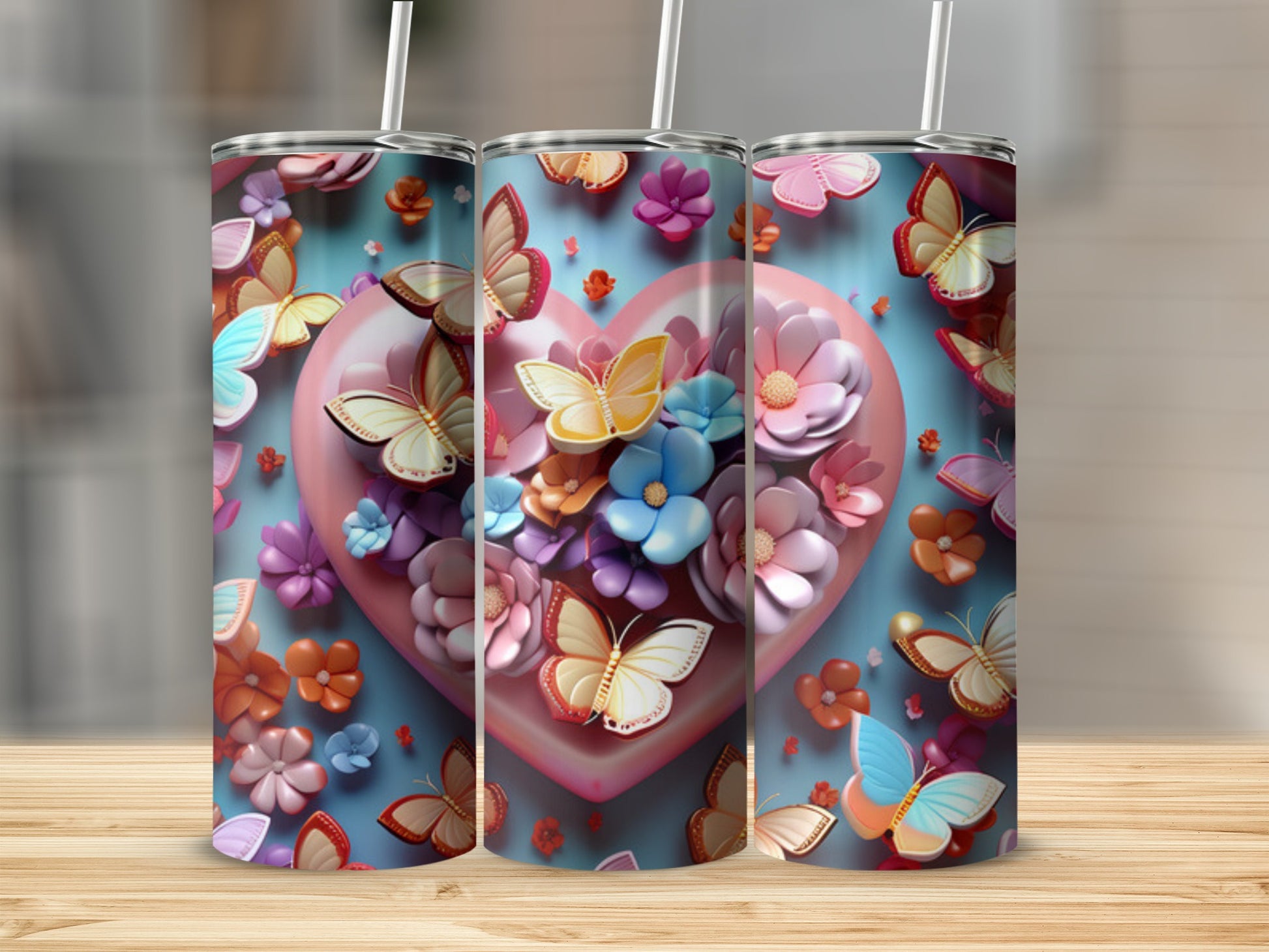 Three tumblers with colorful butterflies and flowers on a heart background.