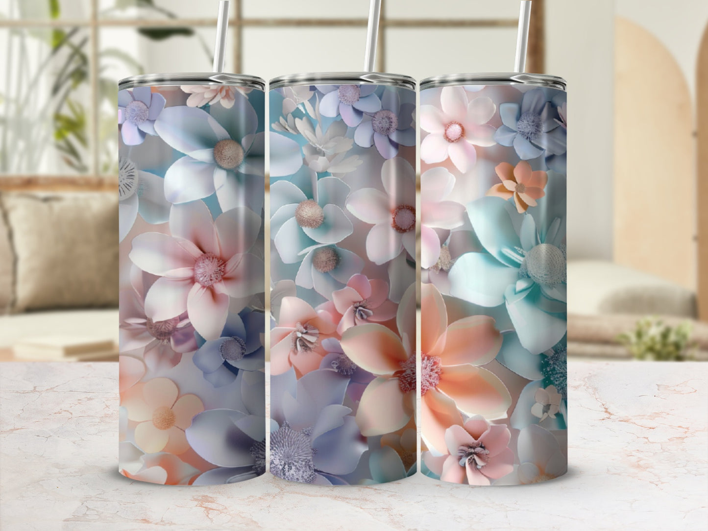 Three tumblers with pastel floral designs on a marble surface.