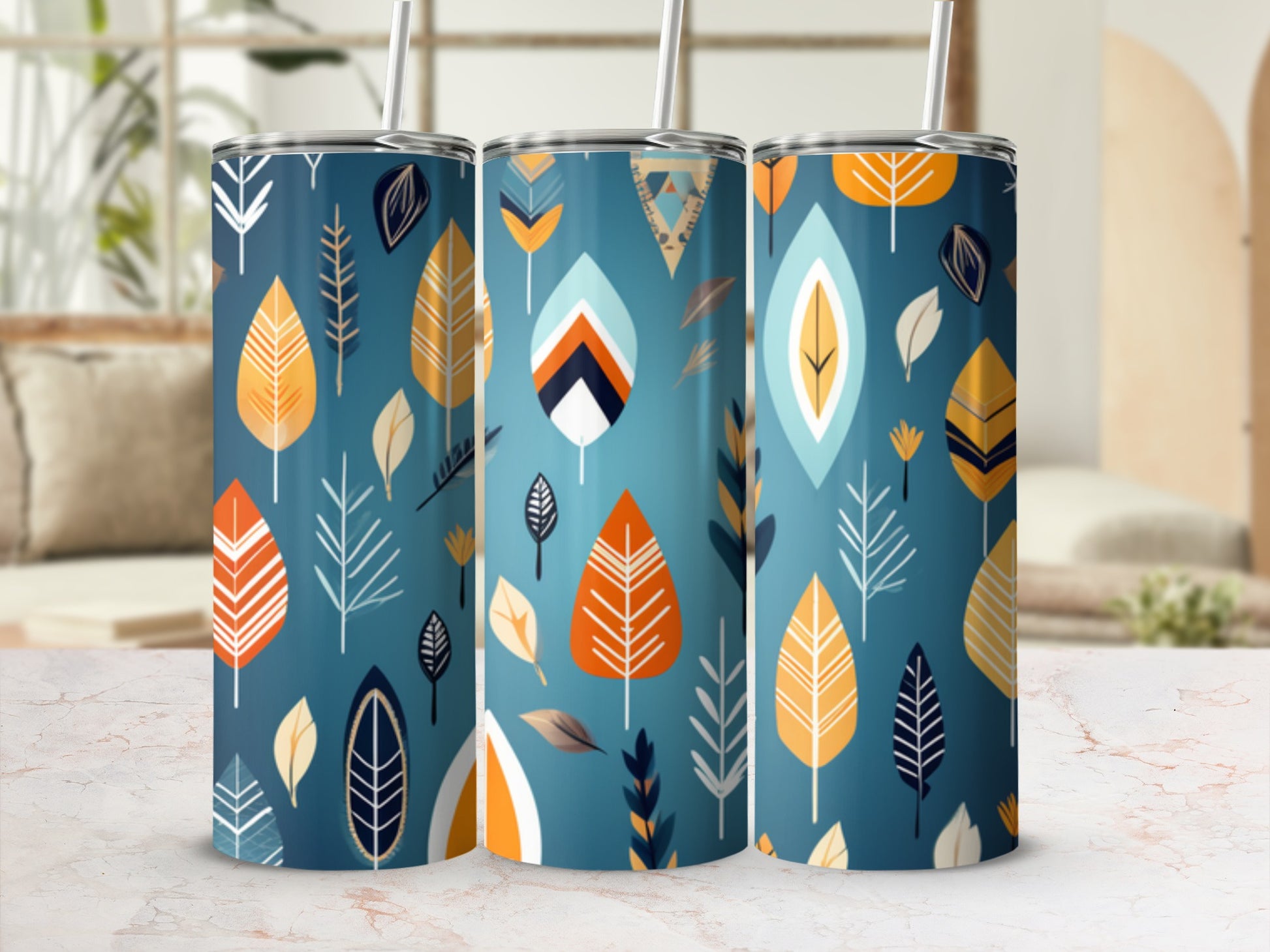 Three tumblers with a blue background and a pattern of colorful leaves.