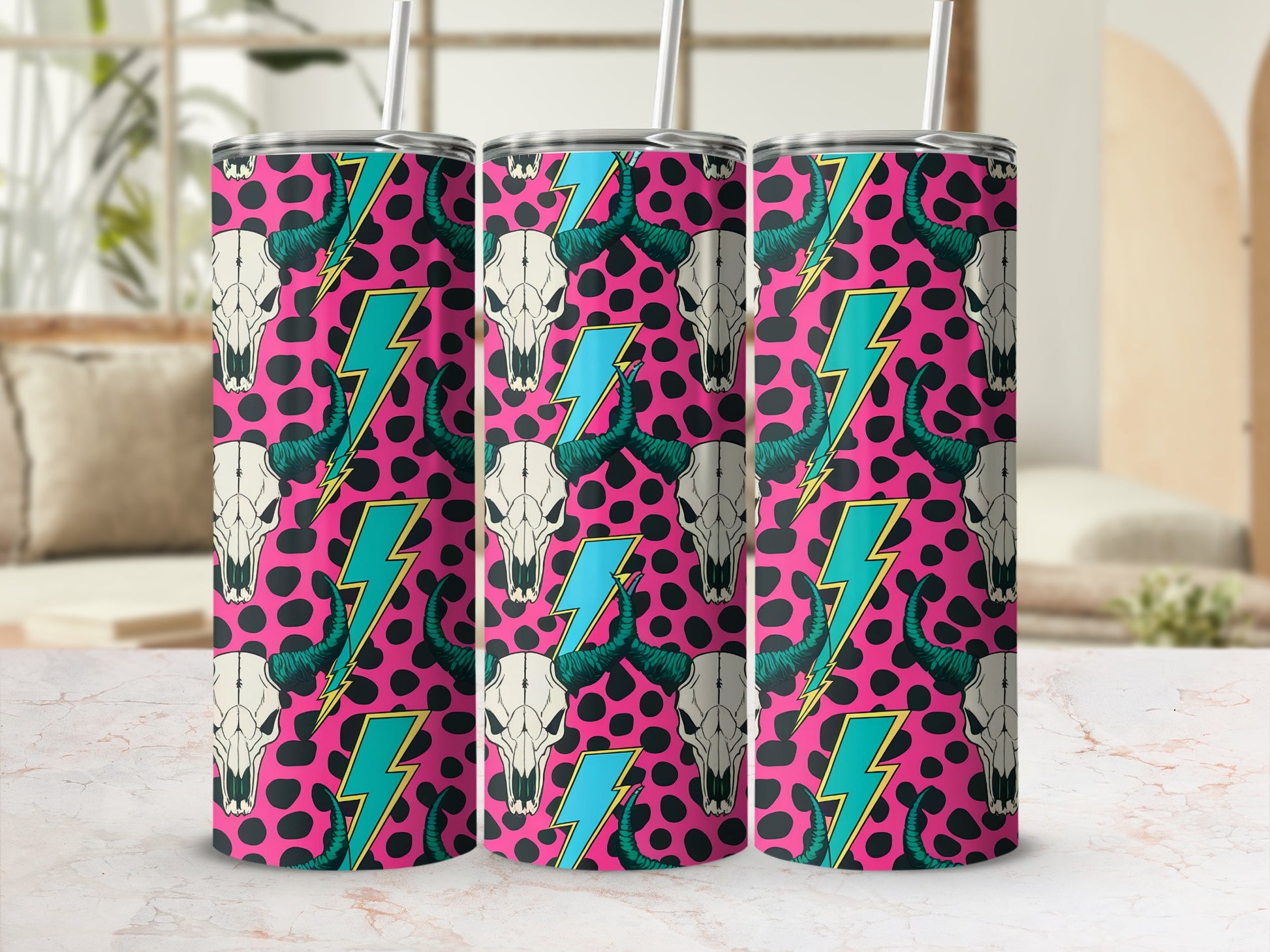 Pink tumbler with black leopard print, cow skulls, and turquoise lightning bolts.