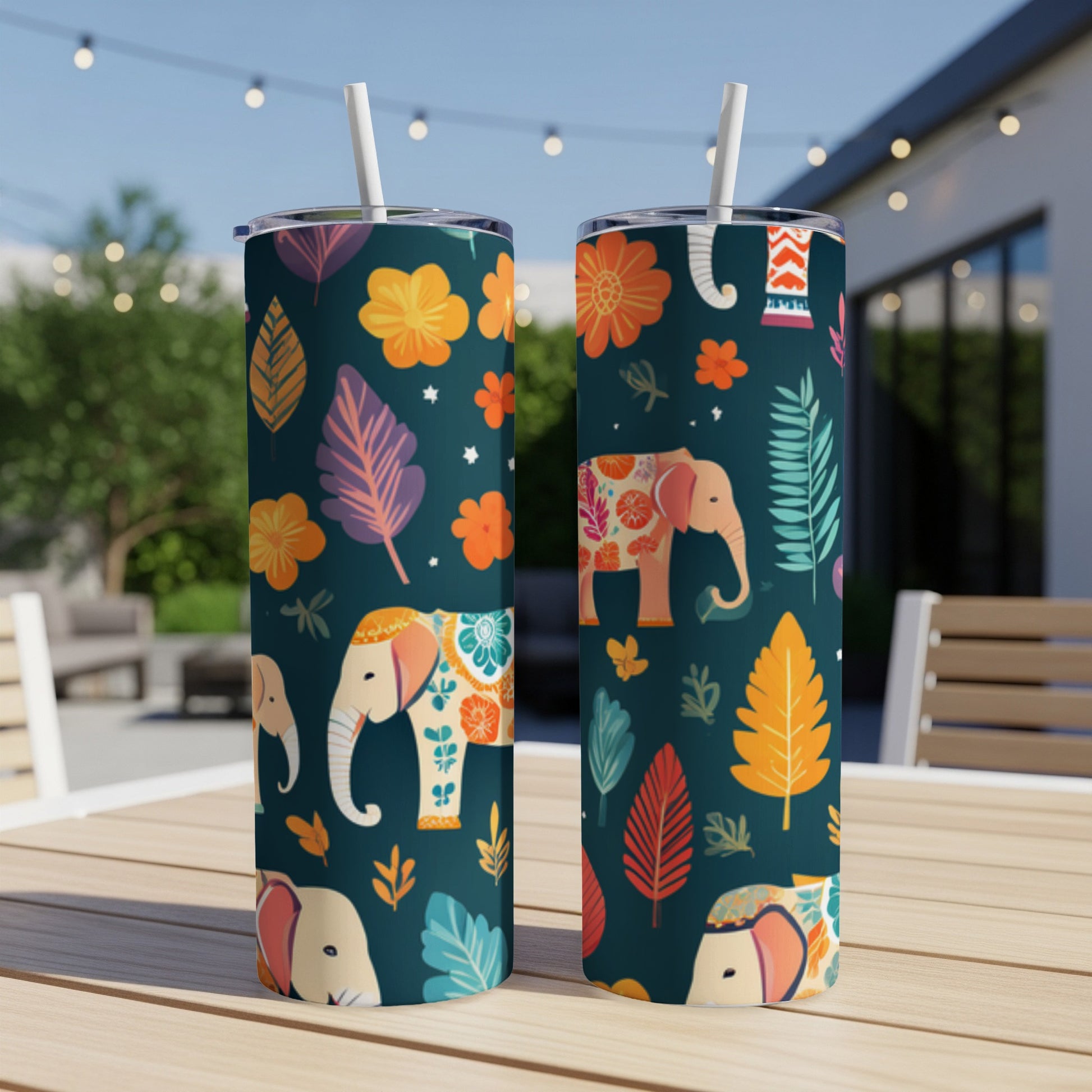 Two tumblers with elephant and floral patterns sit on a table.
