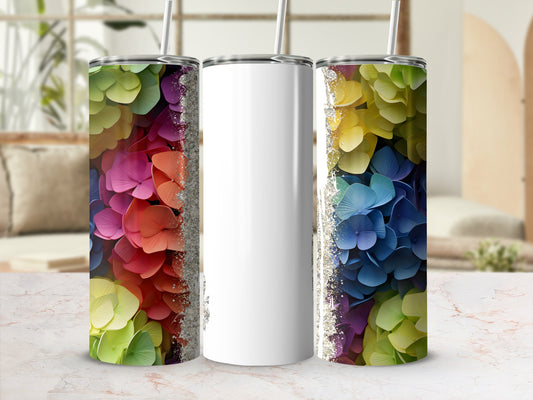 White tumbler with rainbow floral design and glitter accents.