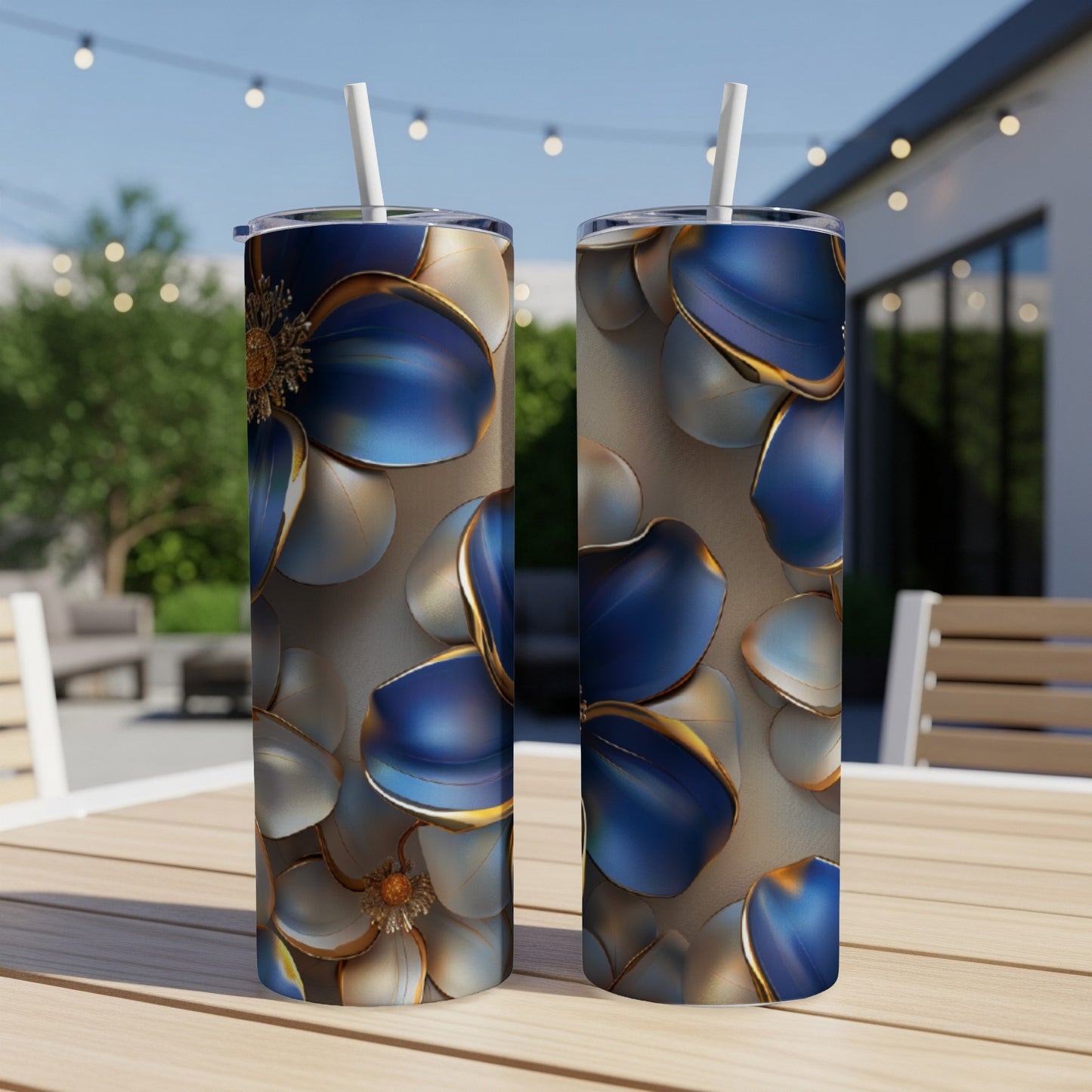 Two tumblers with blue and gold floral patterns on a table.