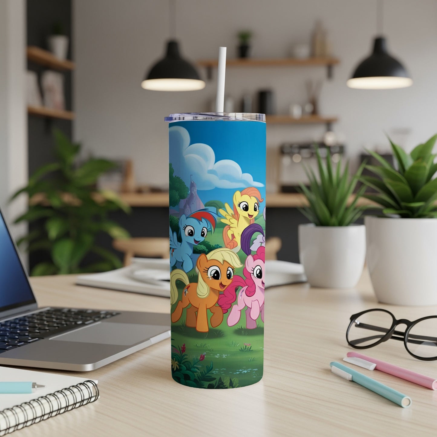My Little Pony characters on a blue tumbler with a straw.
