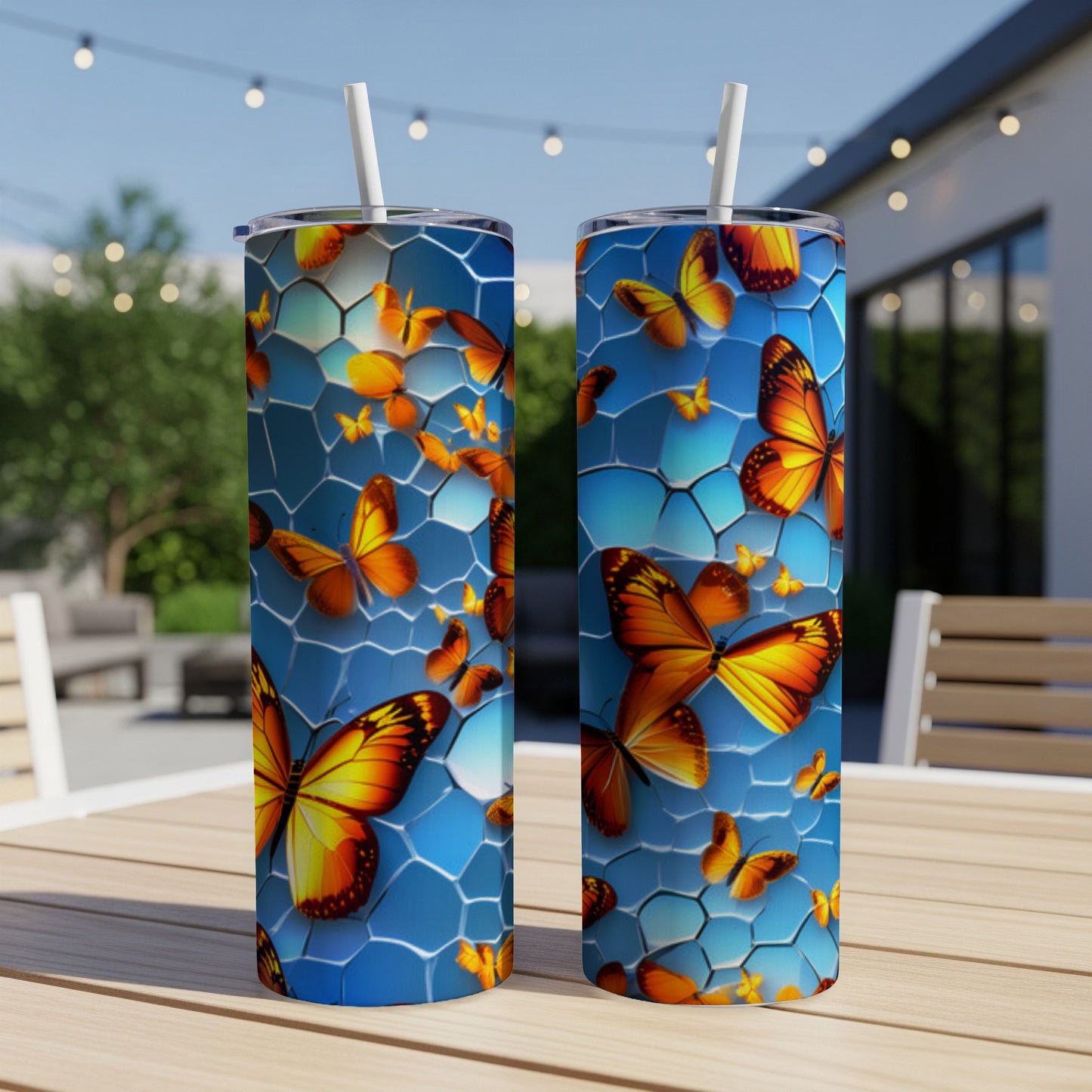 Two tumblers with a blue honeycomb pattern and orange butterflies.