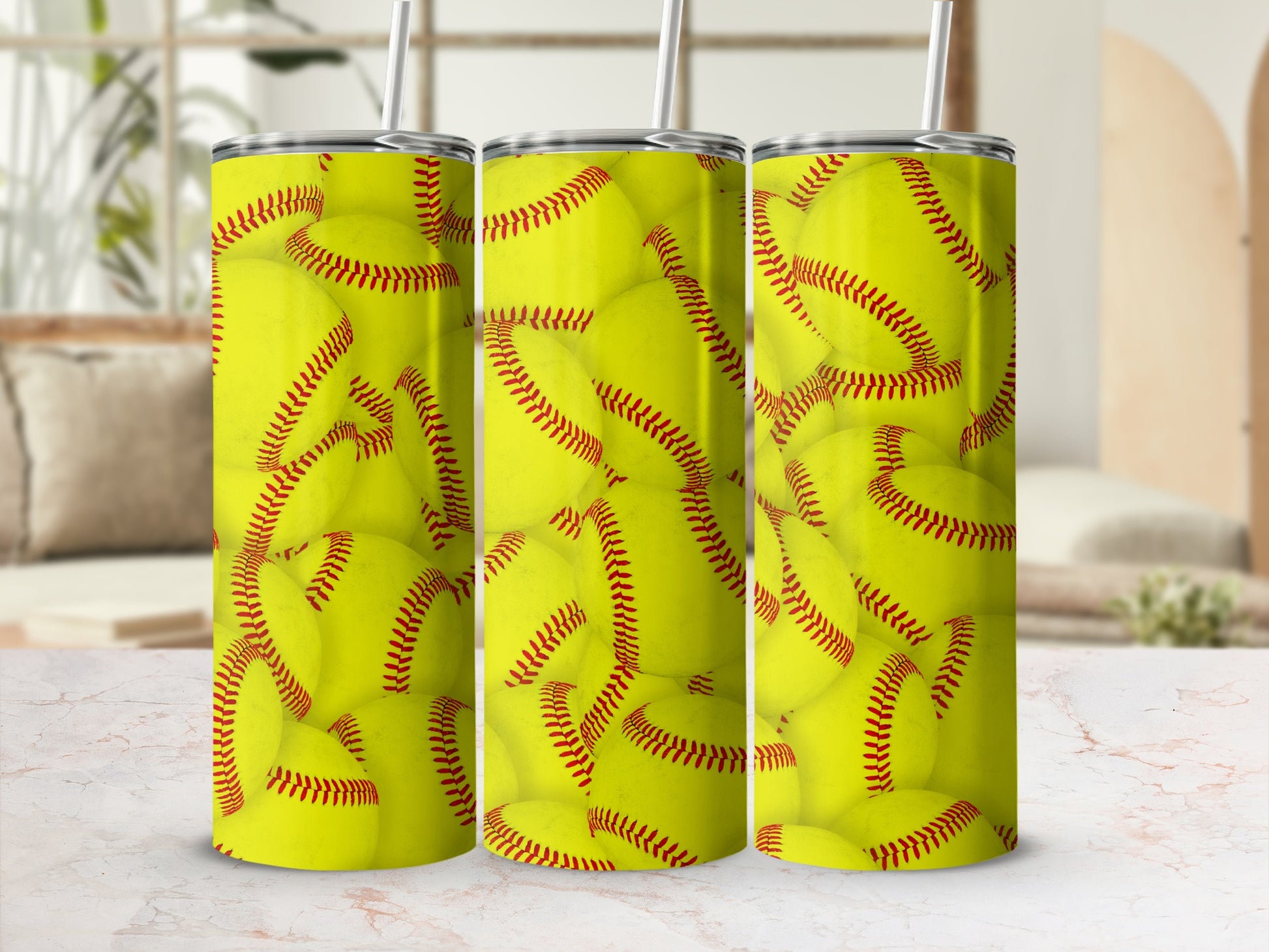 Three tumblers with a repeating pattern of yellow softballs and red stitching.