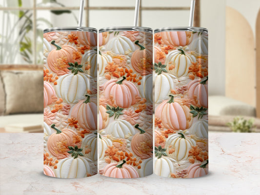 Three tumblers with a pumpkin and leaf pattern on a marble surface.