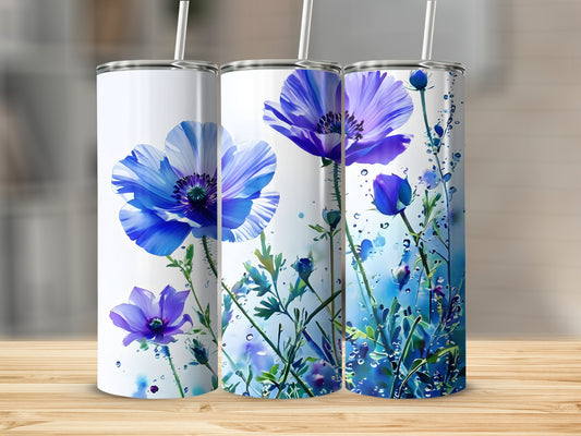 Three tumblers with blue poppy floral designs and water droplets.