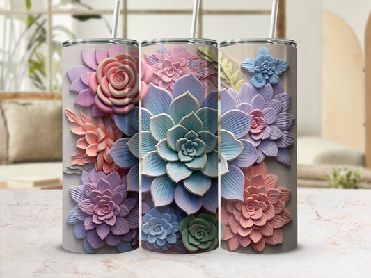 Three pastel floral tumblers with straws against a blurred background.