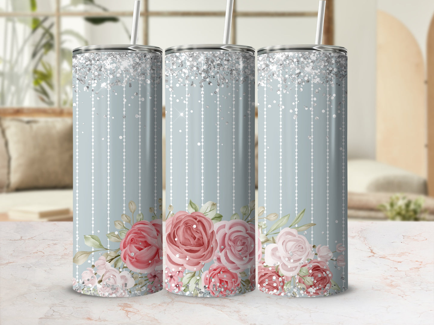 Three tall tumblers with pink floral design and glitter accents.