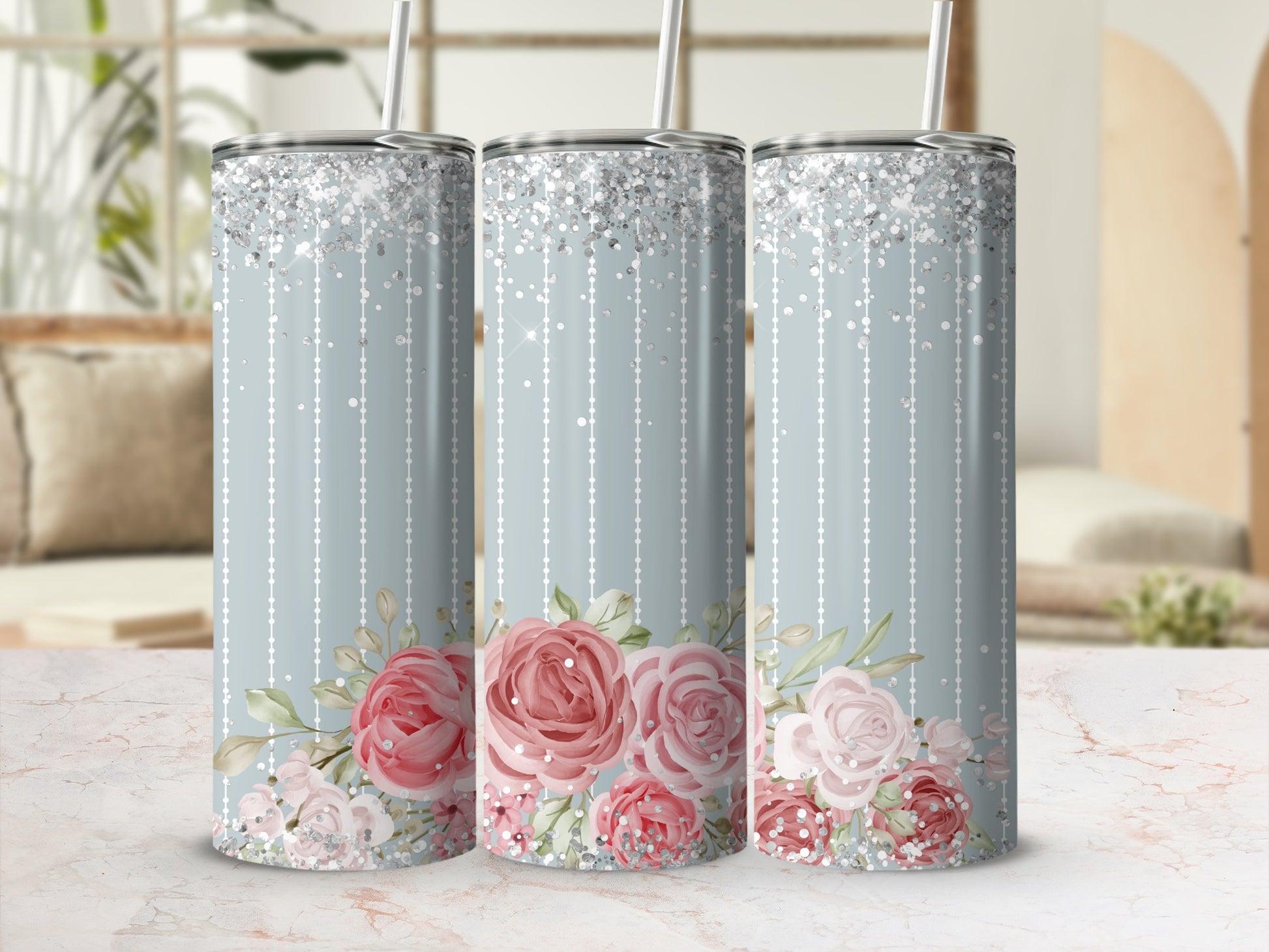 Three tall tumblers with pink floral design and glitter accents.