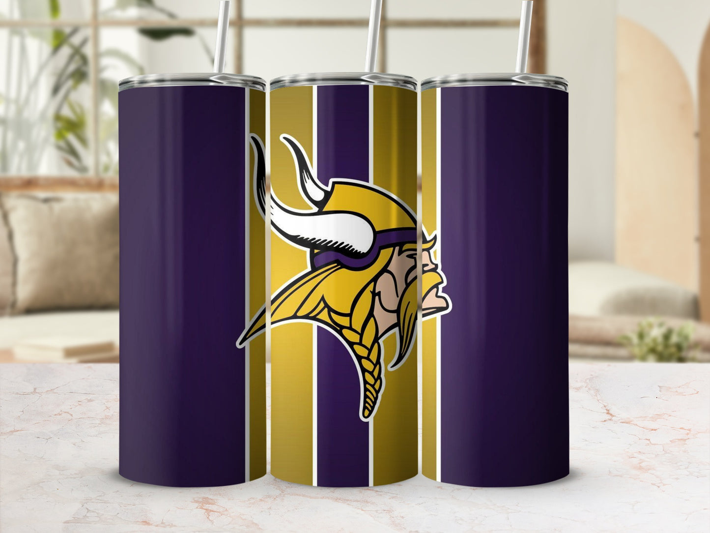 Minnesota Vikings logo on purple and gold striped tumbler with straw