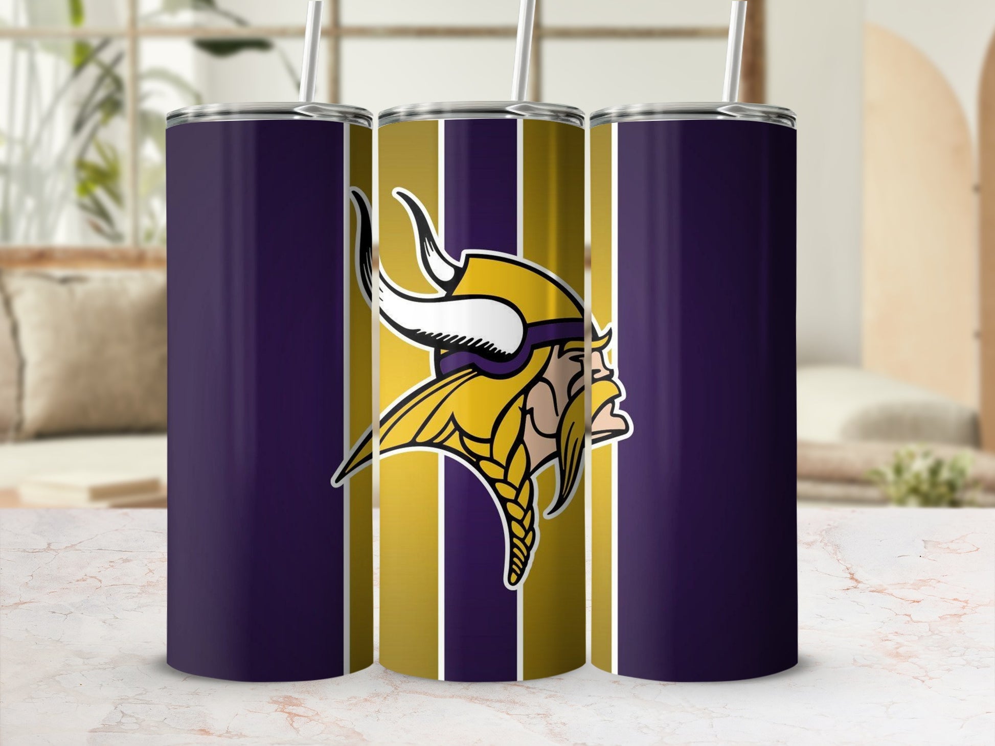 Minnesota Vikings logo on purple and gold striped tumbler with straw