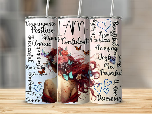 Tumbler with "I AM" and positive affirmations surrounded by butterflies and flowers.