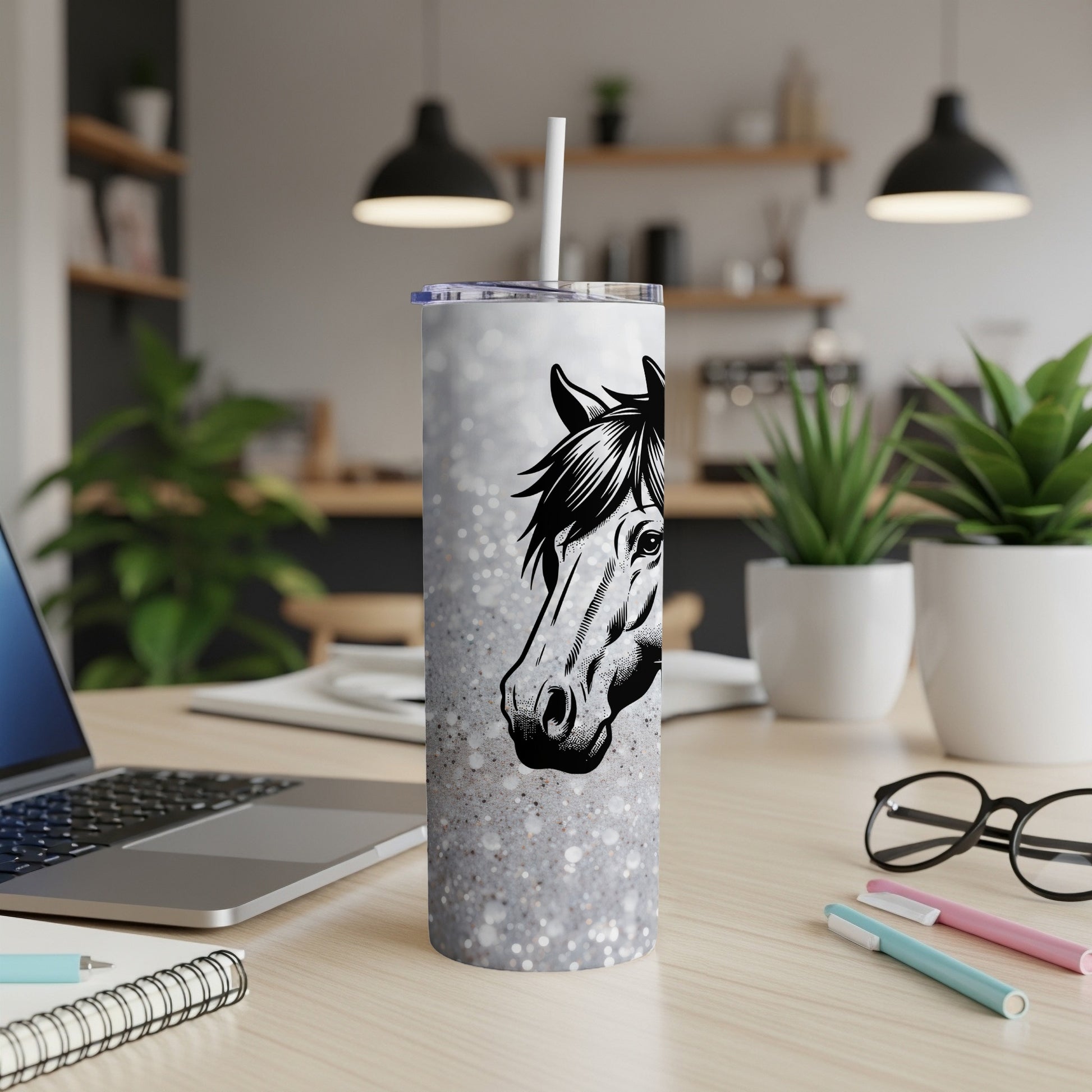 White glitter tumbler with a horse head illustration on a desk.