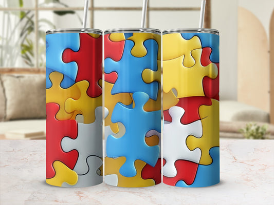 Three tumblers with a colorful puzzle piece design in red, blue, yellow, and white.