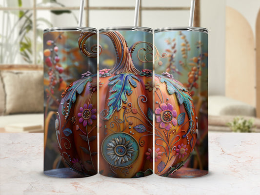 Tumbler with a decorative pumpkin design, featuring floral and swirling accents.