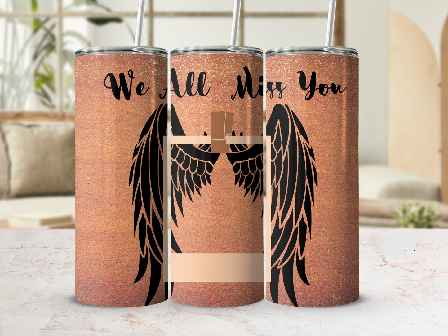 Copper tumbler with black angel wings, cross, and "We All Miss You" text.