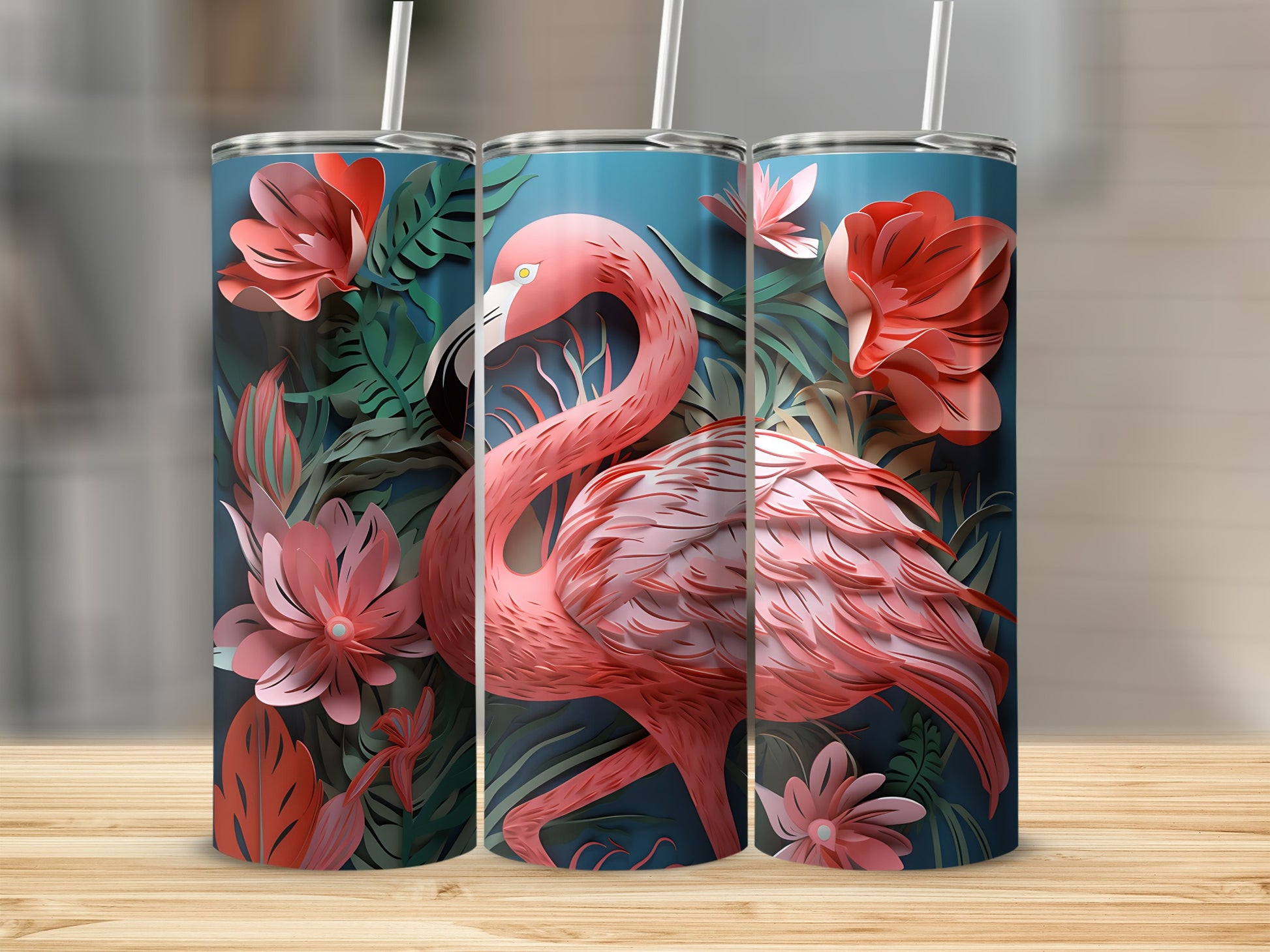 Flamingo and floral pattern on three stainless steel tumblers with straws.