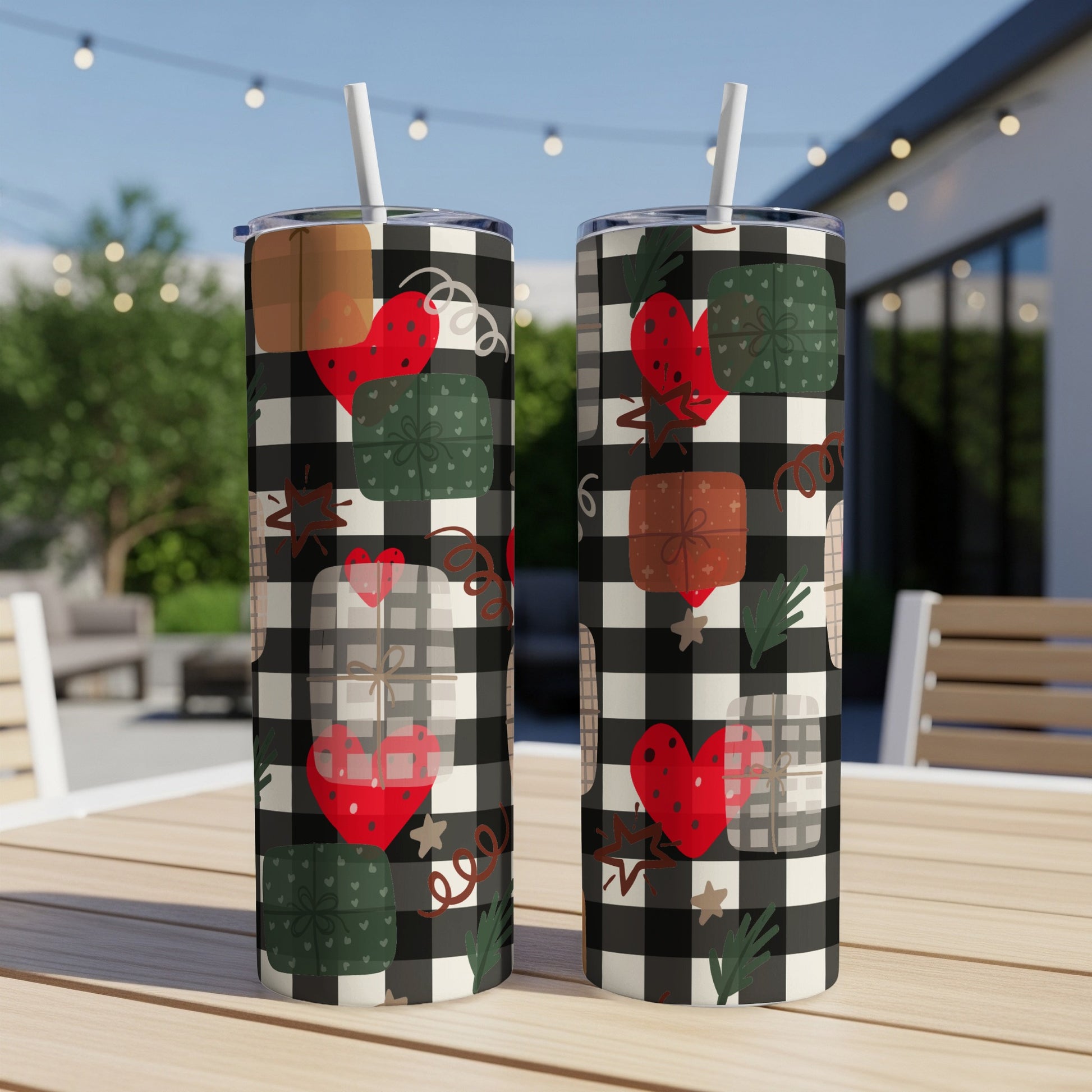 Two tumblers with heart and gift box pattern on checkered background.