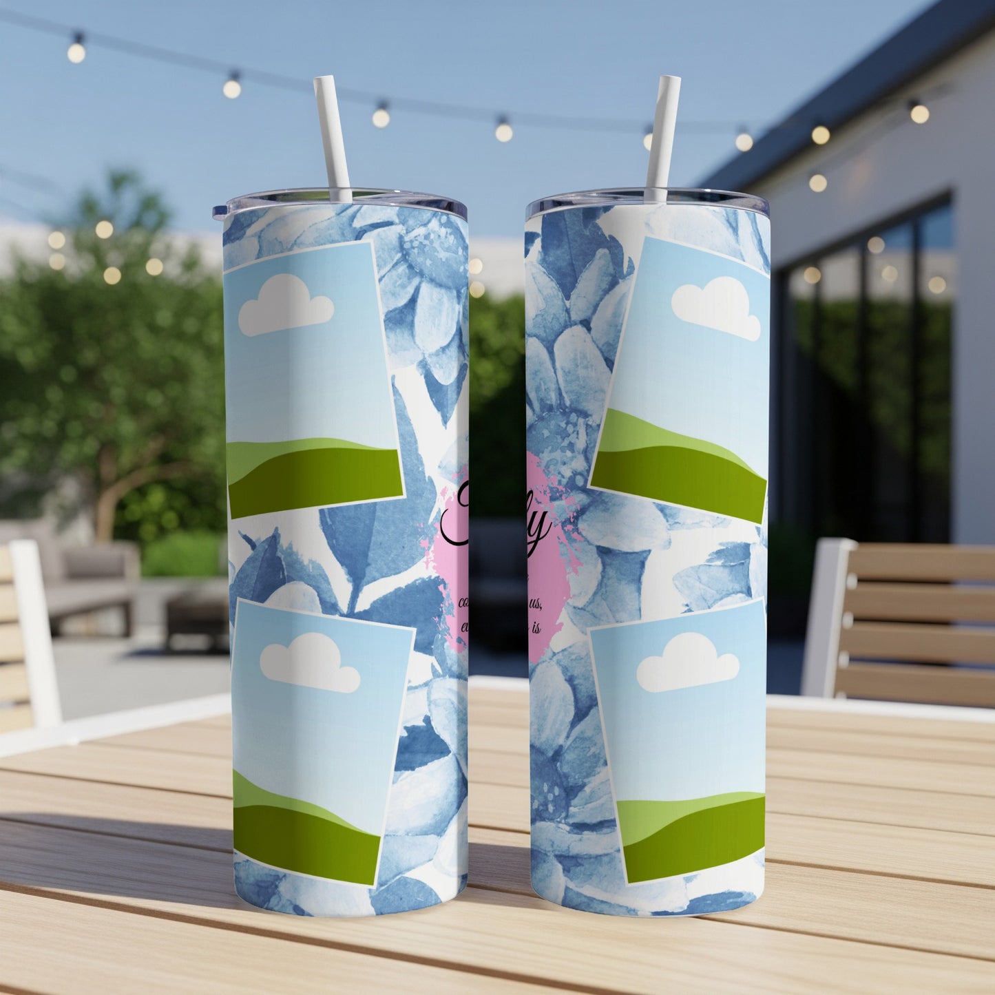 Two tumblers with blue floral pattern, clouds, and rolling green hills.
