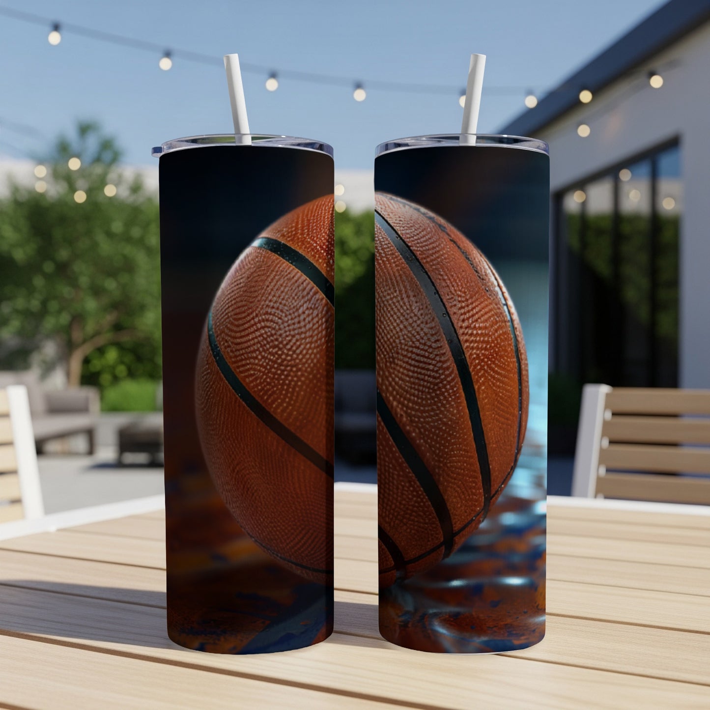 Two tumblers with a basketball design, placed on a table outdoors.