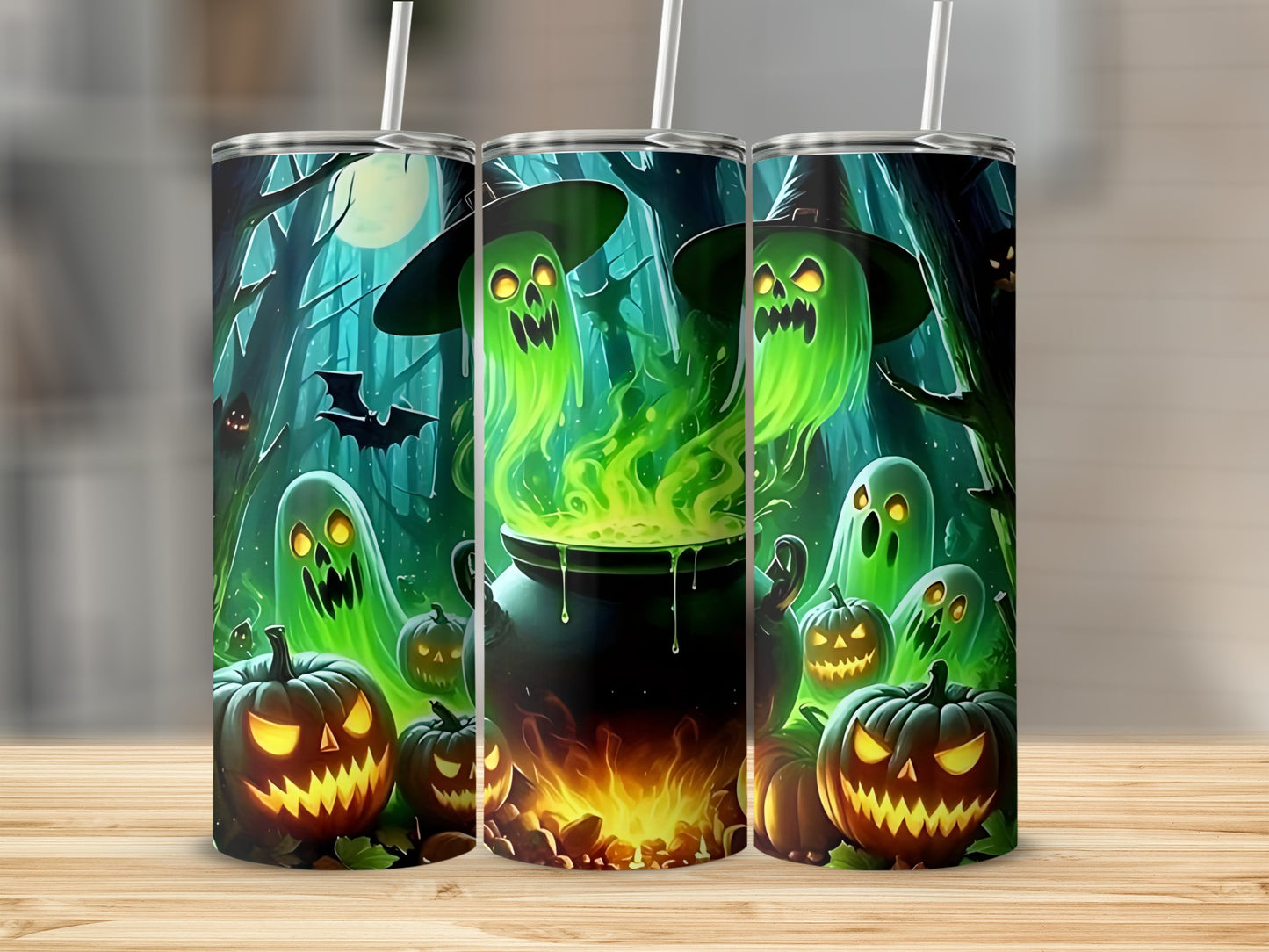 Three tumblers with a Halloween design featuring glowing ghosts and jack-o'-lanterns.