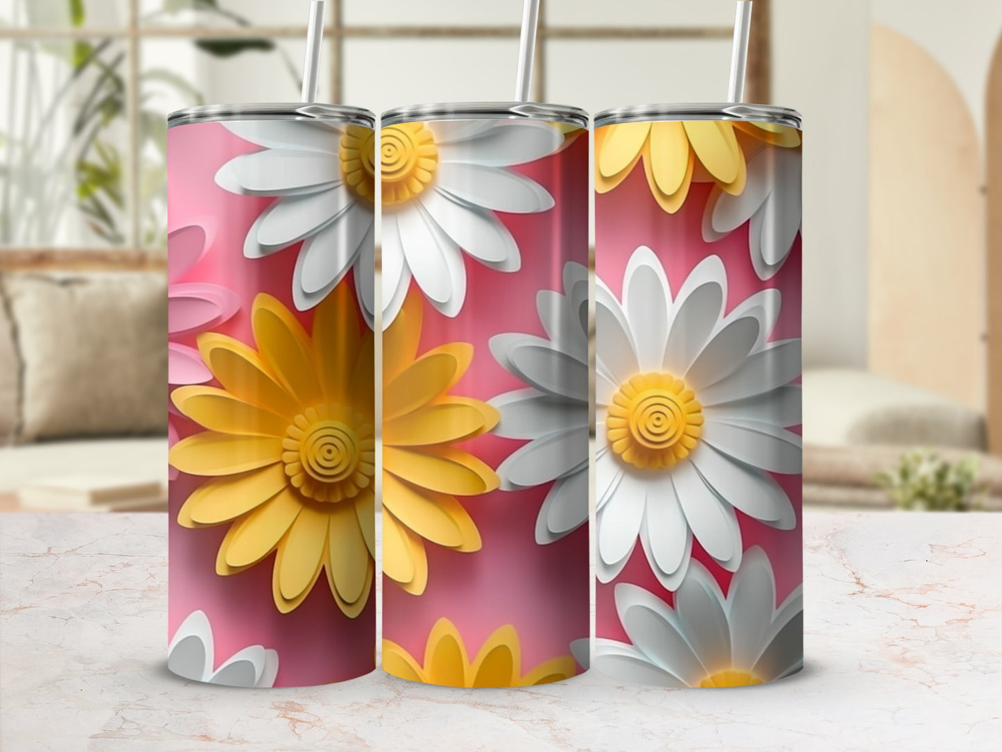 Three tumblers with a pink background and a repeating pattern of yellow and white daisies.