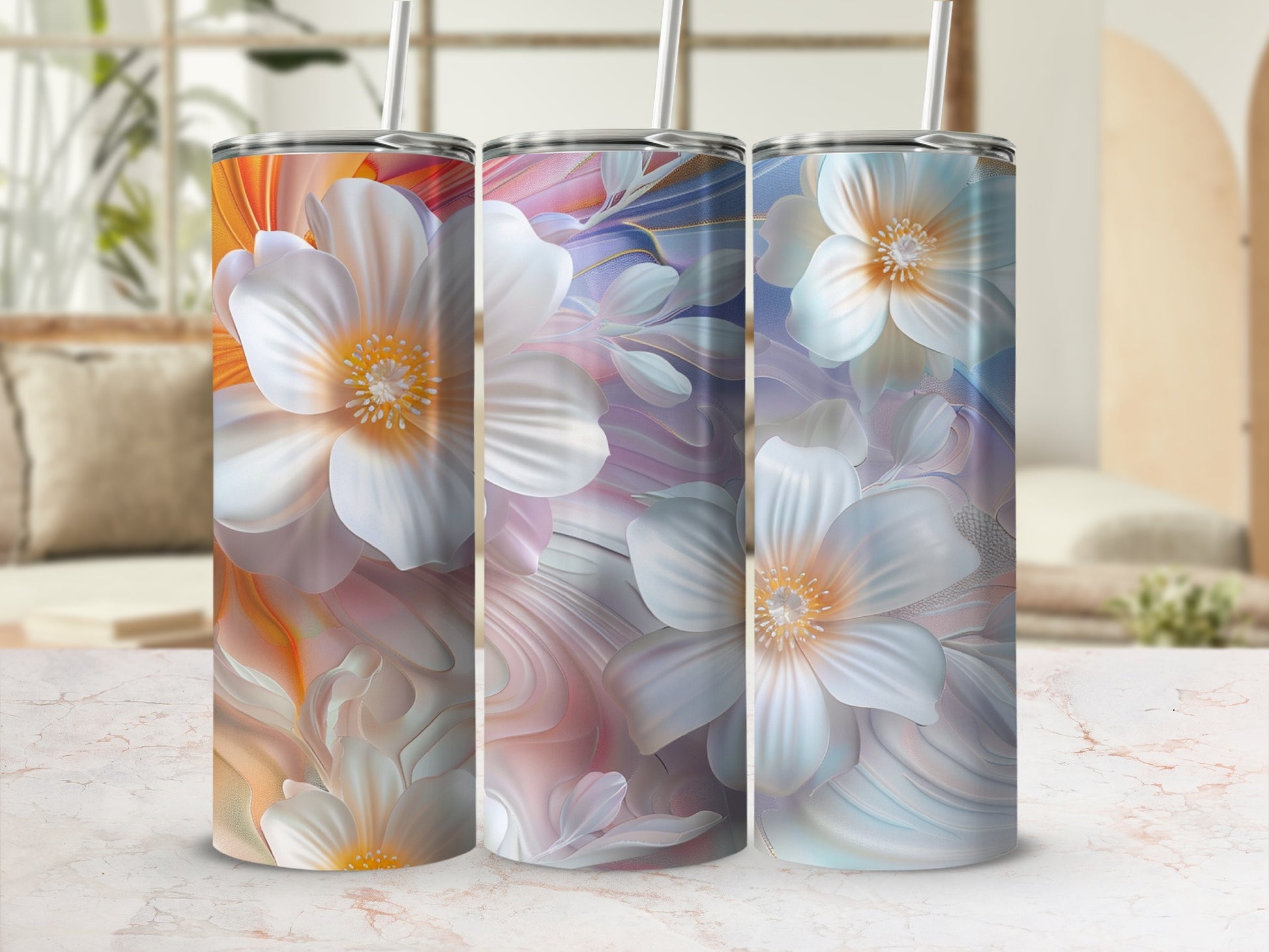 Three tumblers with white floral designs on a marble countertop.