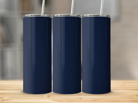 Three navy blue tumblers with white straws stand on a wooden surface.