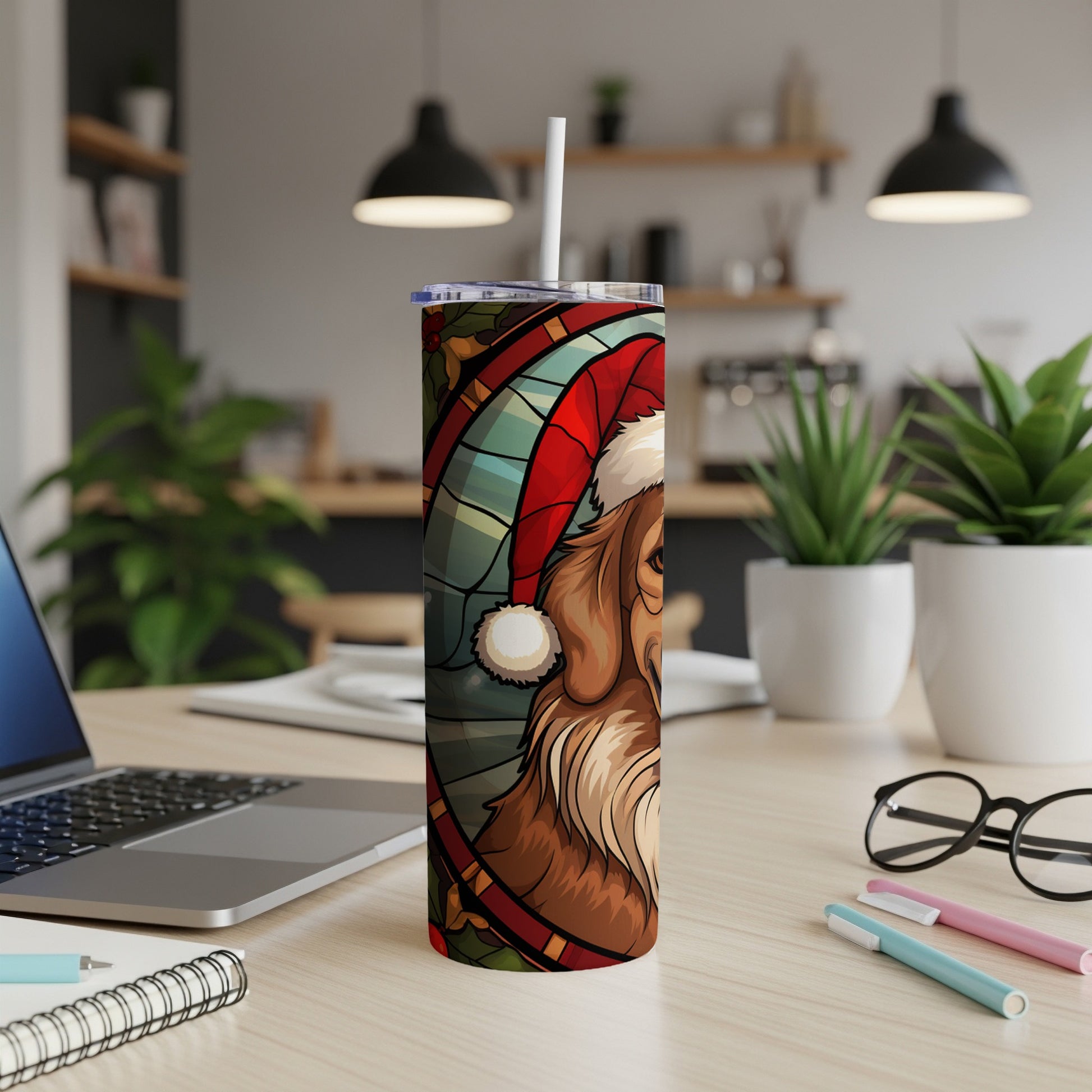 Santa dog tumbler with straw on a desk.
