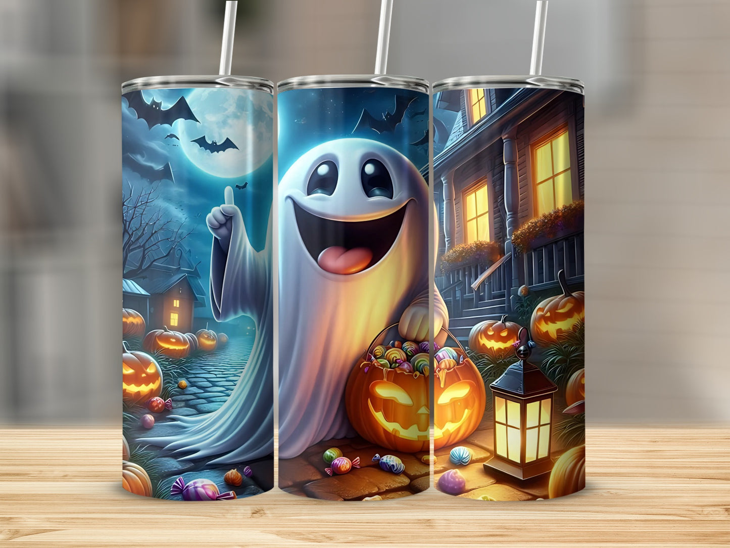Three tumblers with Halloween designs featuring ghosts, pumpkins, candy, and bats.