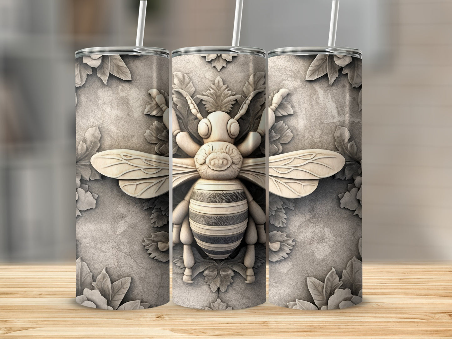 Three textured tumblers featuring a raised, ornate bee design on a stone-like background.