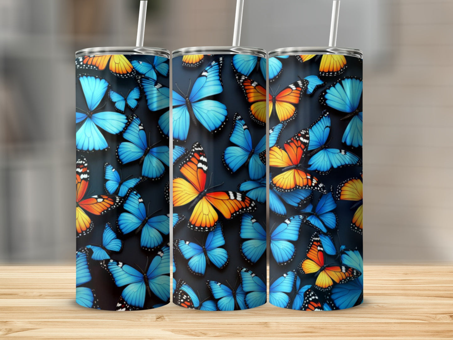 Triptych of tumblers with a vibrant butterfly pattern.