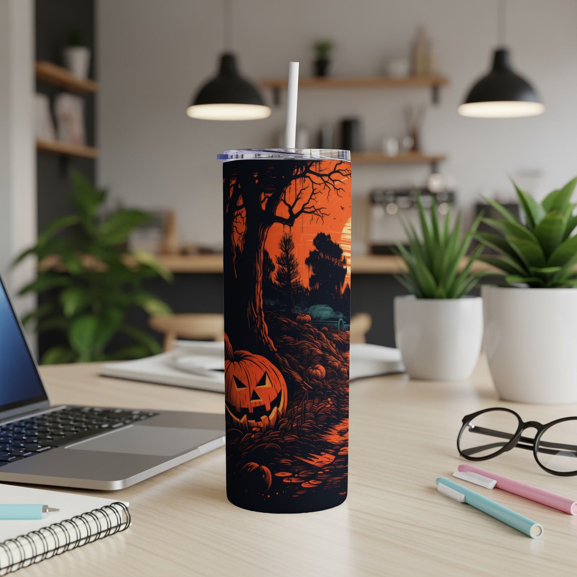 Tumbler with Halloween scene featuring a jack-o'-lantern and spooky trees.