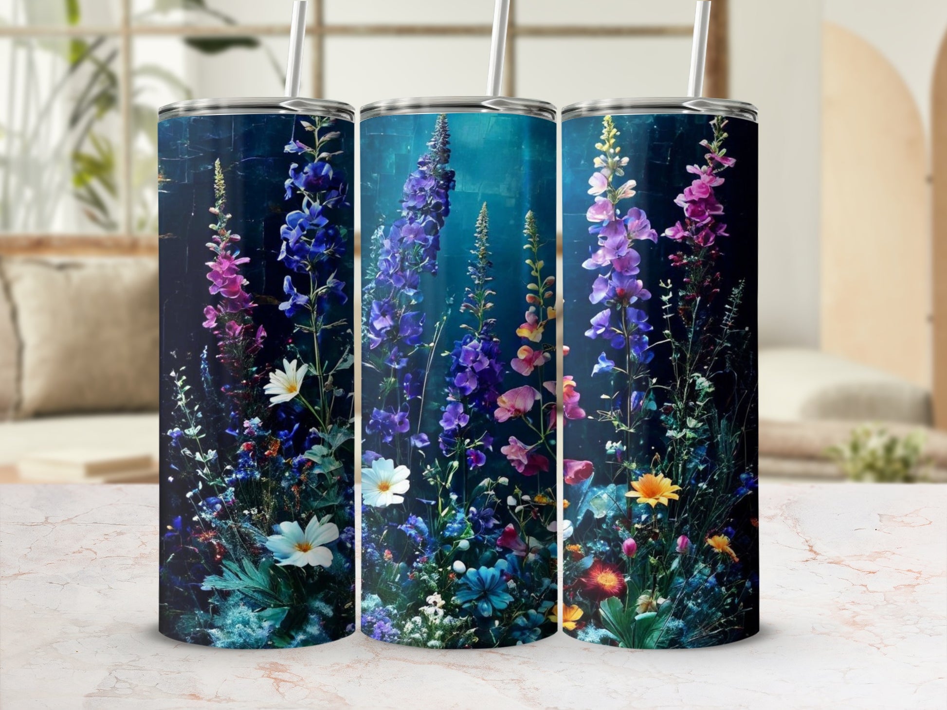Three tumblers adorned with vibrant wildflowers and foliage.