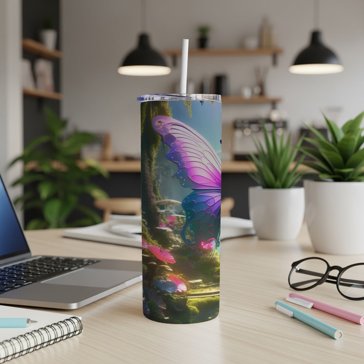Pink and purple butterfly art on a stainless steel tumbler with a straw.