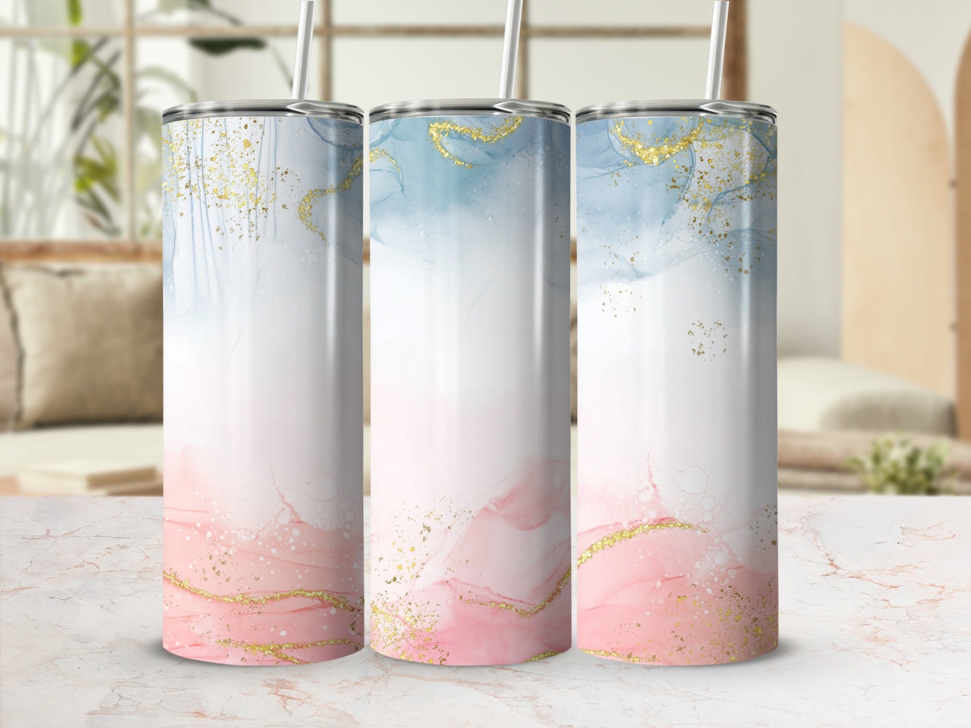 Three tumblers with abstract watercolor and gold glitter designs.