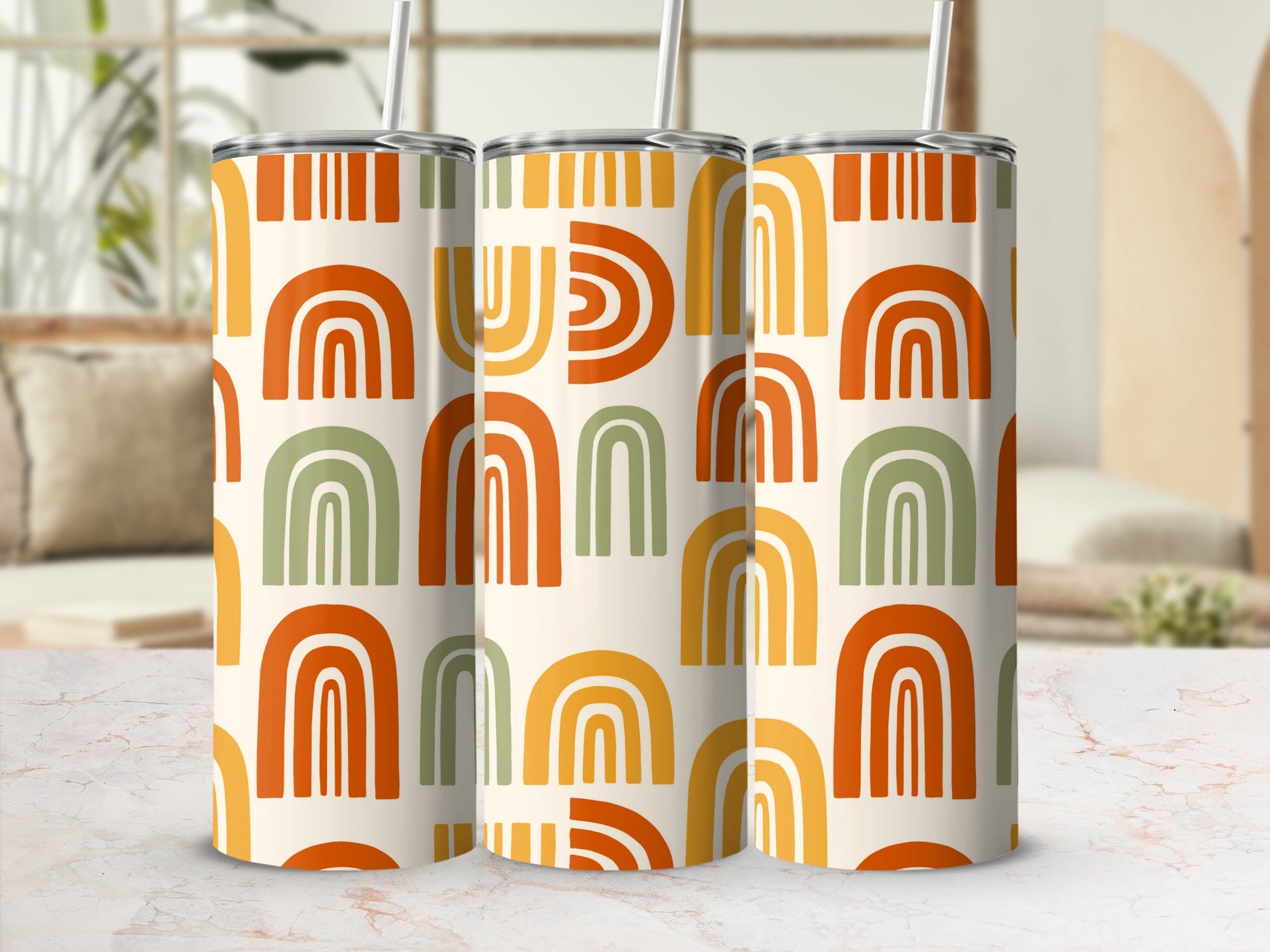 Three tumblers with orange, yellow, and green abstract rainbow pattern.