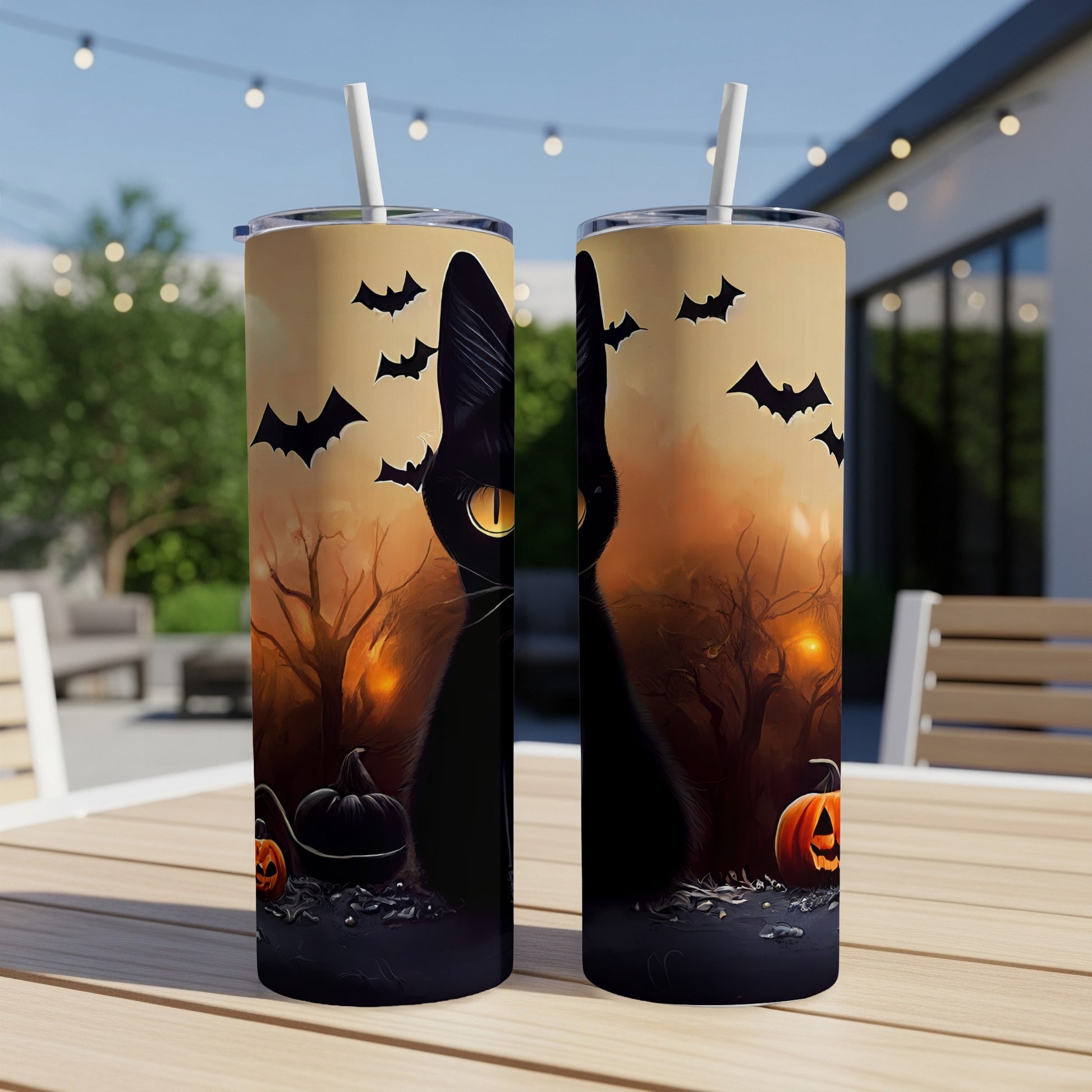 Two Halloween-themed tumblers with black cats, bats, pumpkins, and spooky trees.