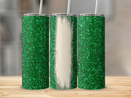 Three green glitter tumblers with straw on a wooden surface.