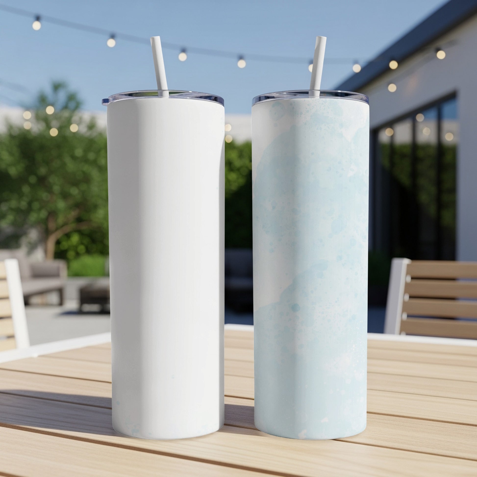 Two stainless steel tumblers, one white, one with blue watercolor design.