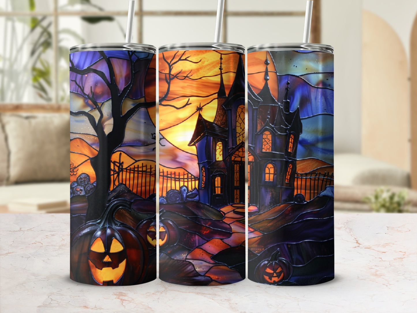 Three tumblers with spooky Halloween haunted house and pumpkin designs.