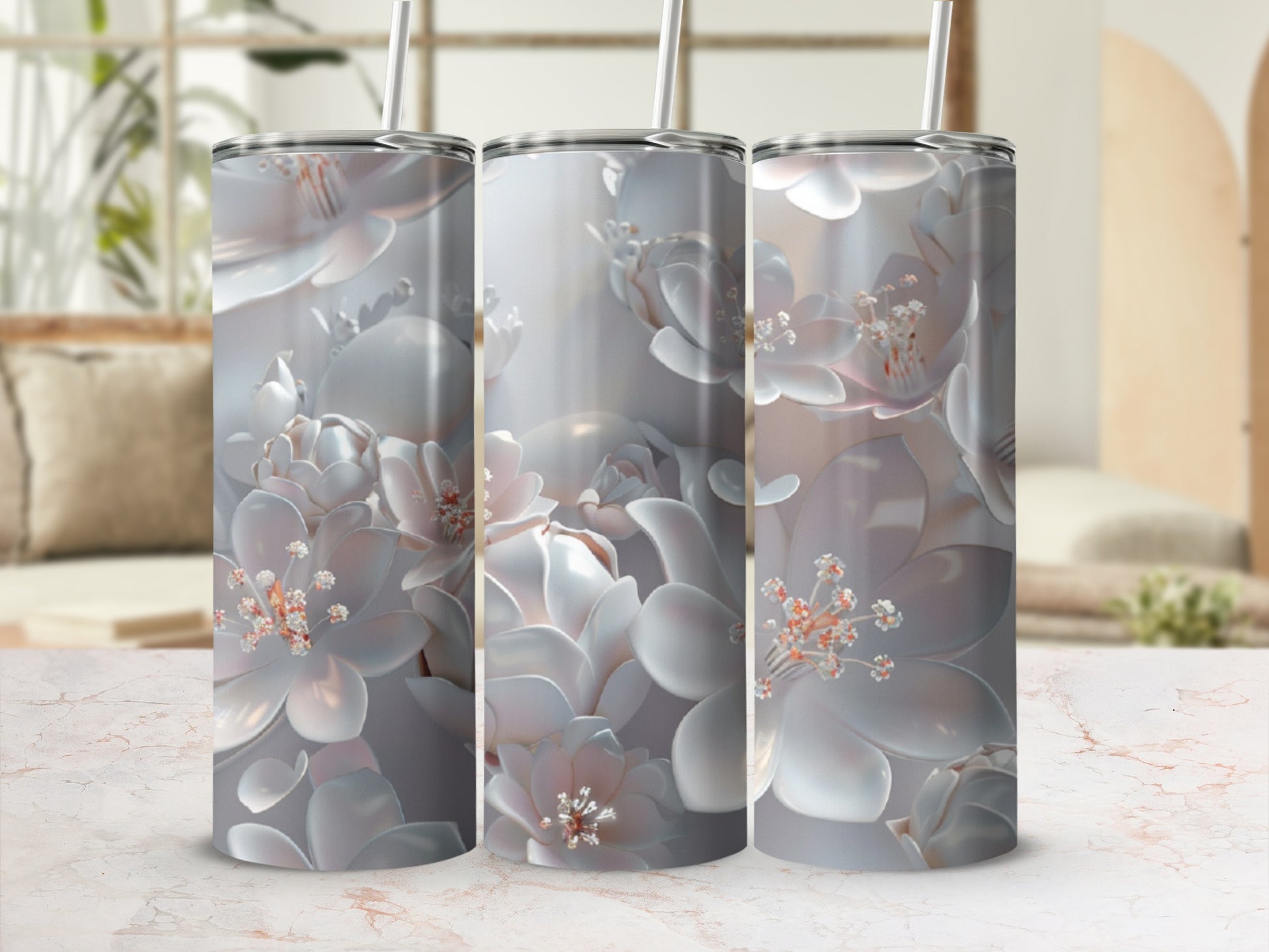 Three tumblers with a pale floral relief pattern on a marble surface.