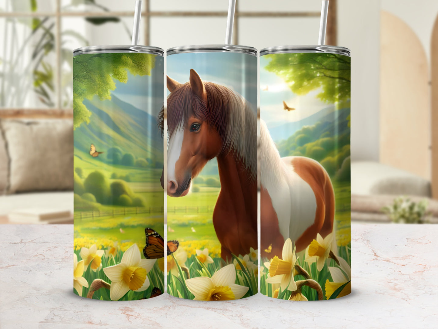 Horse and floral pattern on three tumblers, with a blurred background.