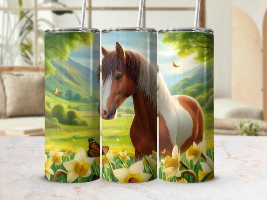 Horse and floral pattern on three tumblers, with a blurred background.